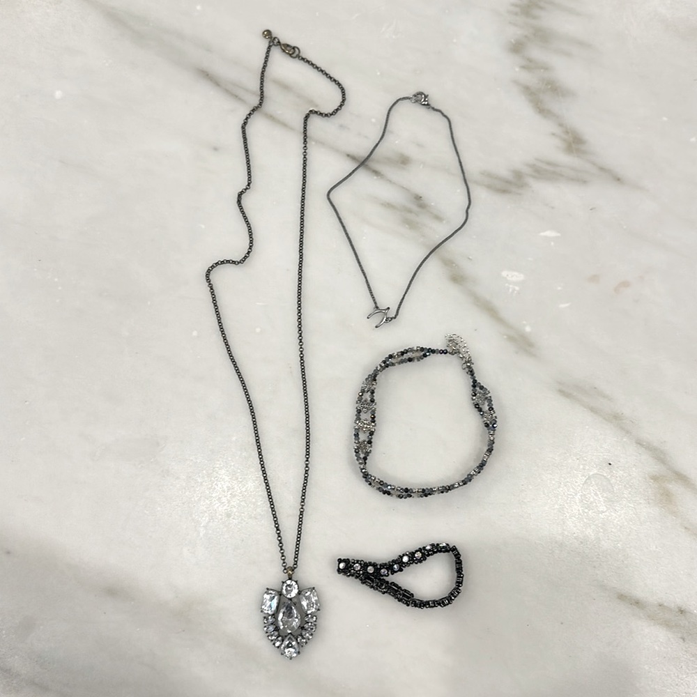 3 necklaces & 1 black bracelet. Choker is silver w/ black blue &  gray beads.